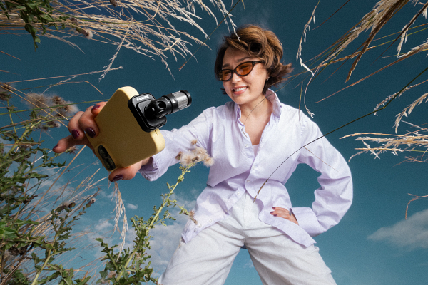 A person holding a cameraAI-generated content may be incorrect.